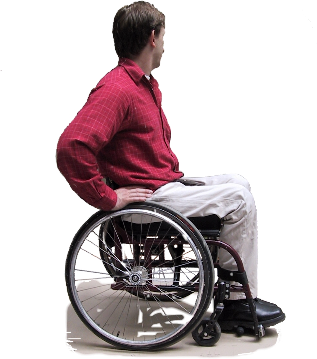 Photo showing the side view of a man in a rear-wheel drive manual wheelchair